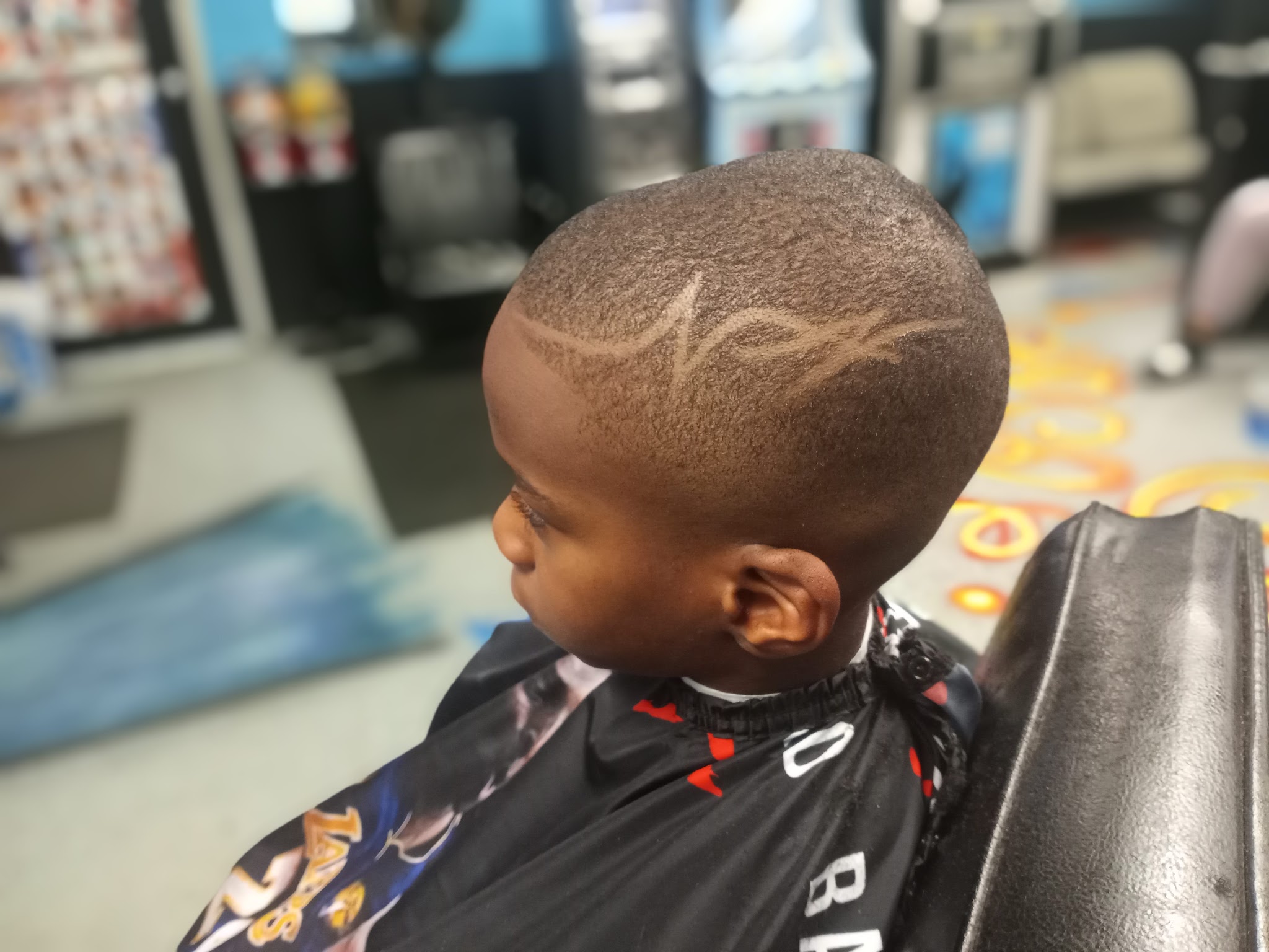 A young client in the chair with a fresh line design
