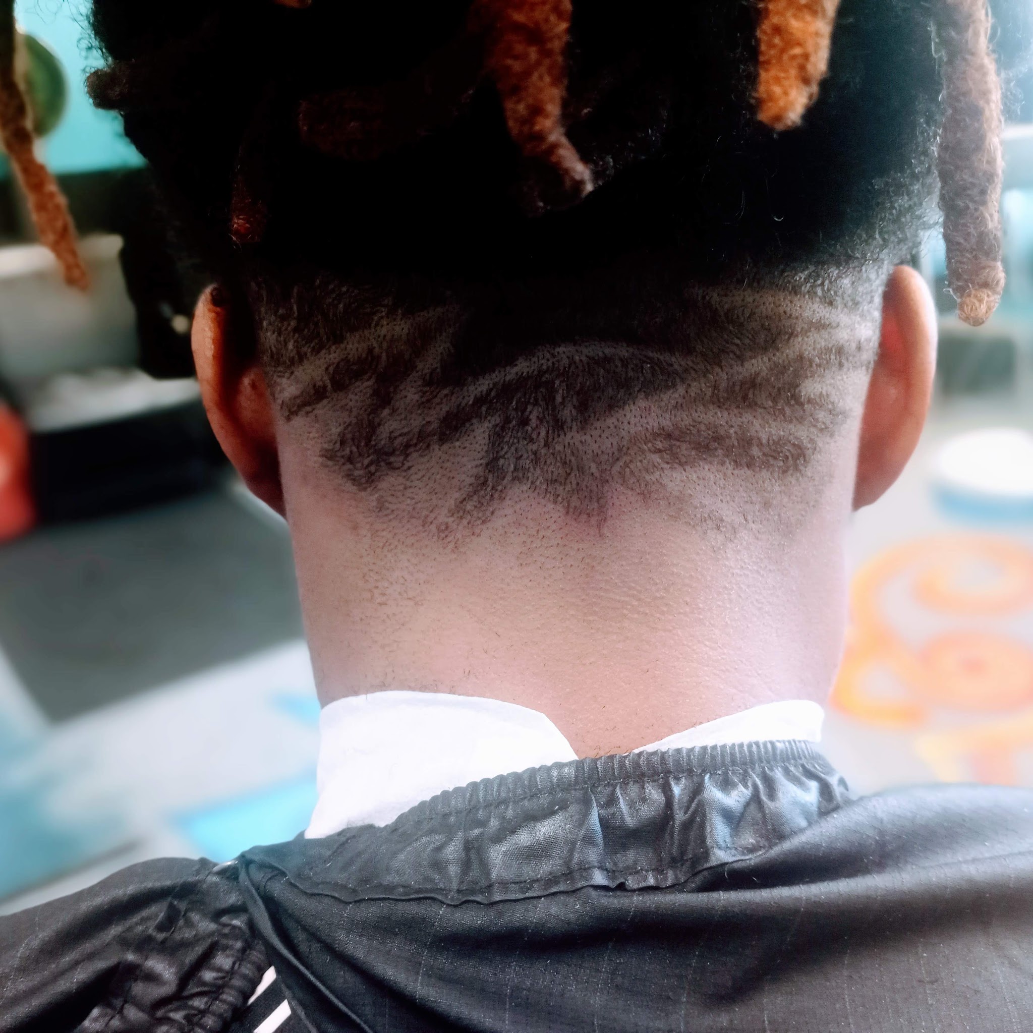 A sharp neckline and design on twisted locs